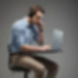 A person slouching while using a laptop