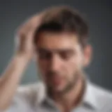 A person holding their head in discomfort, representing a hangover headache